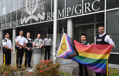 Photo  Officers Raising Pride Flag