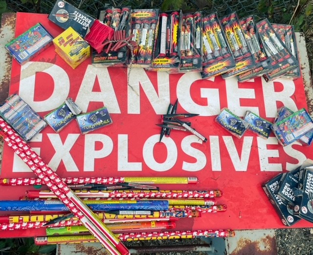 A large quantity of explosives on top of a "Danger" sign