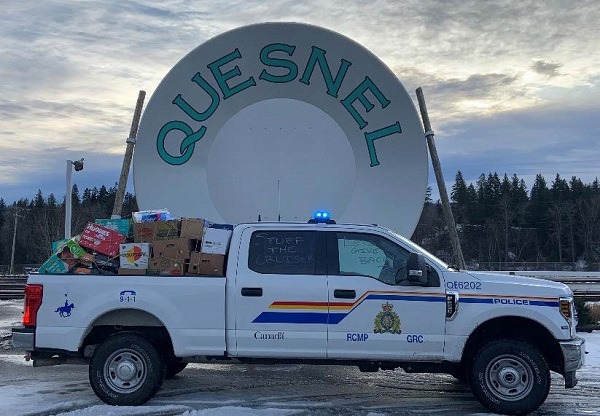Police truck filled with donated items in front of the Quesnel Gold Pan